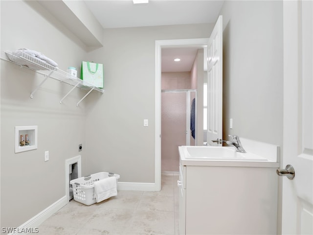 laundry room featuring hookup for an electric dryer, washer hookup, light tile patterned flooring, and sink