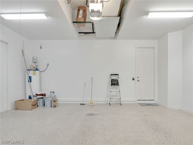 garage featuring electric water heater and a garage door opener