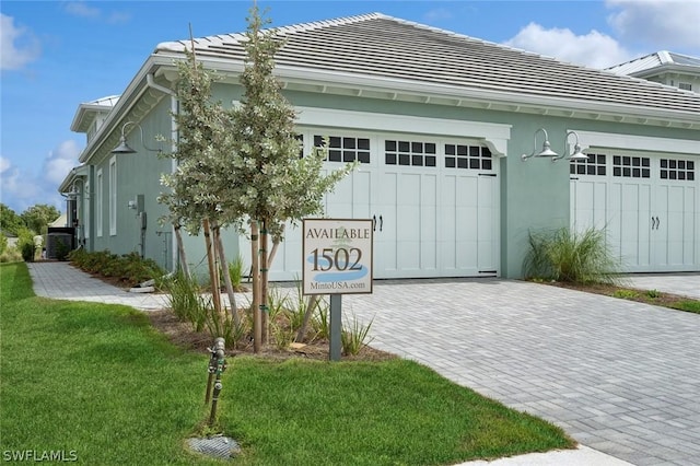 view of front of property with a front yard and a garage