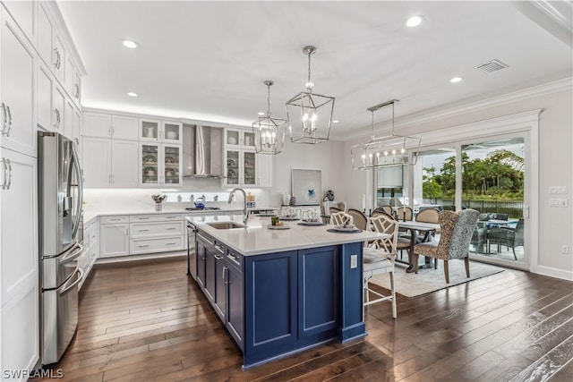 kitchen with a sink, white cabinets, light countertops, stainless steel fridge with ice dispenser, and glass insert cabinets