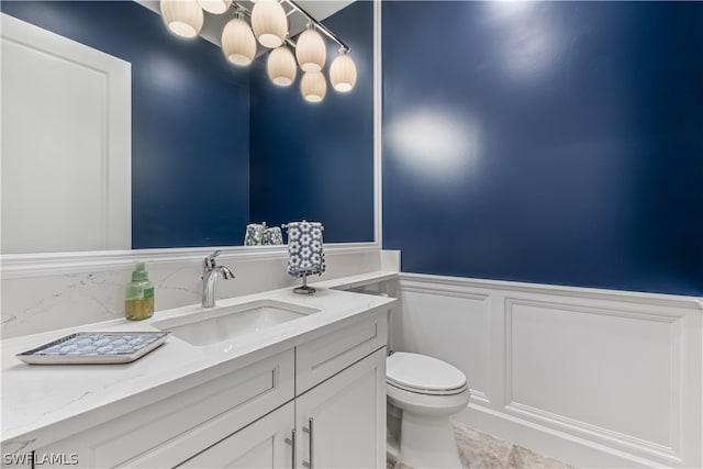 bathroom featuring tile patterned flooring, vanity, and toilet