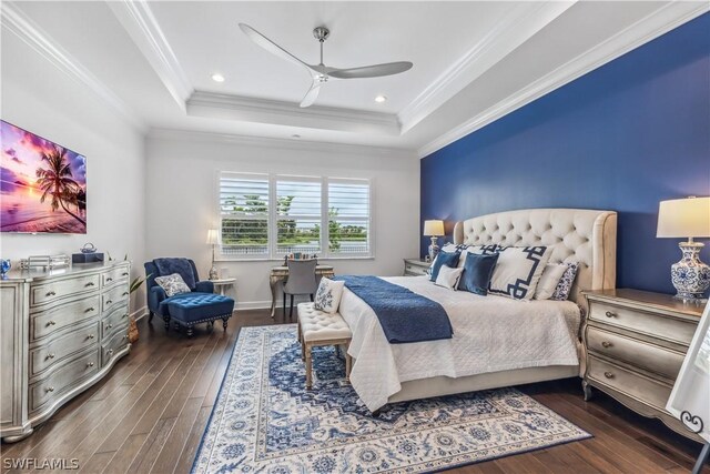 bedroom featuring dark hardwood / wood-style flooring, ornamental molding, and ceiling fan