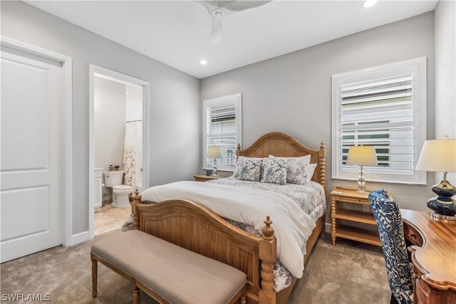 carpeted bedroom featuring ensuite bathroom and ceiling fan