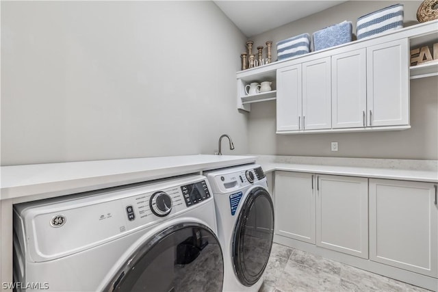 laundry room with cabinet space and washing machine and dryer