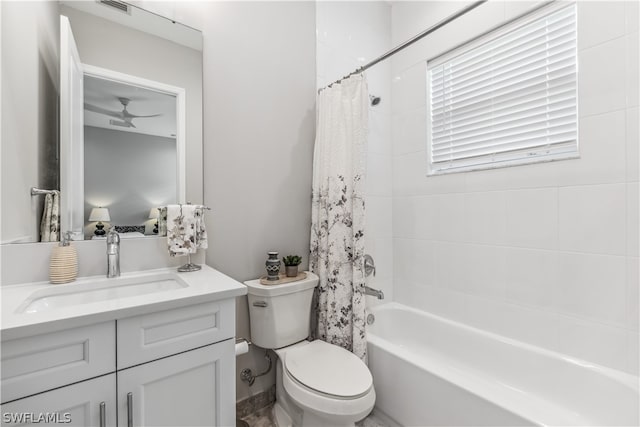 full bathroom featuring vanity, ceiling fan, toilet, and shower / tub combo with curtain