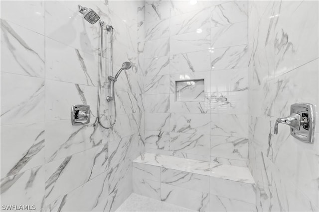 full bath featuring tiled shower