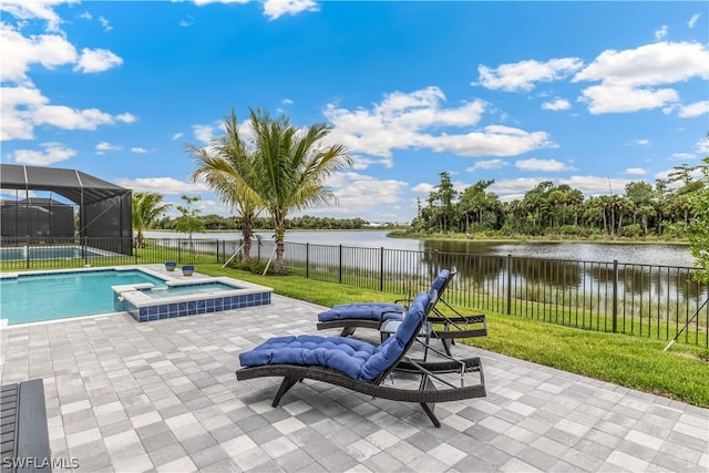 view of pool featuring a fenced backyard, a water view, a pool with connected hot tub, a lawn, and a patio area