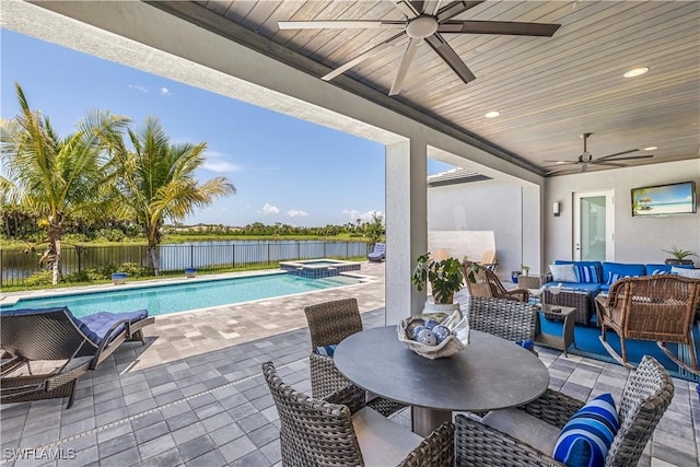 view of patio with outdoor dining area, a pool with connected hot tub, an outdoor hangout area, a ceiling fan, and a fenced backyard