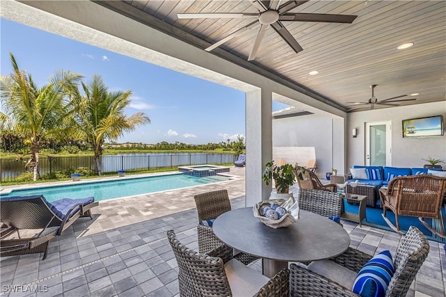 12043 Datura Pl, Naples, FL 34120 - view of patio featuring a pool with connected hot tub, an outdoor hangout area, a fenced backyard, a water view, and a ceiling fan