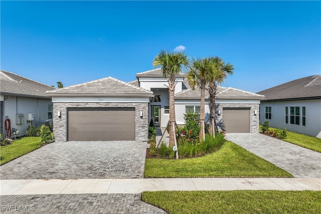 view of front of home featuring a garage and a front yard