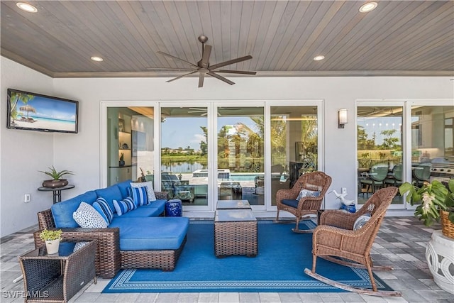 view of patio / terrace with a water view, an outdoor living space, a ceiling fan, and french doors