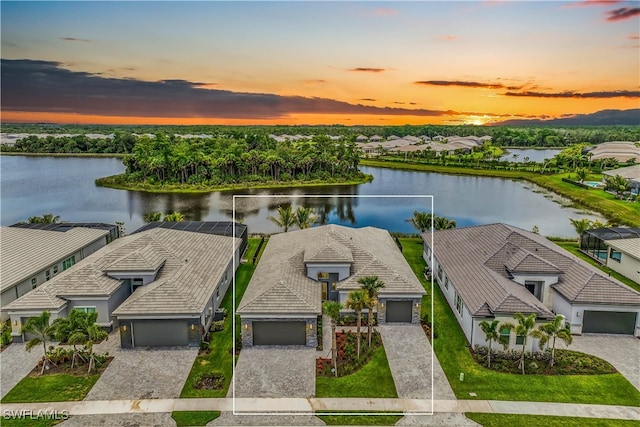 aerial view at dusk with a water view