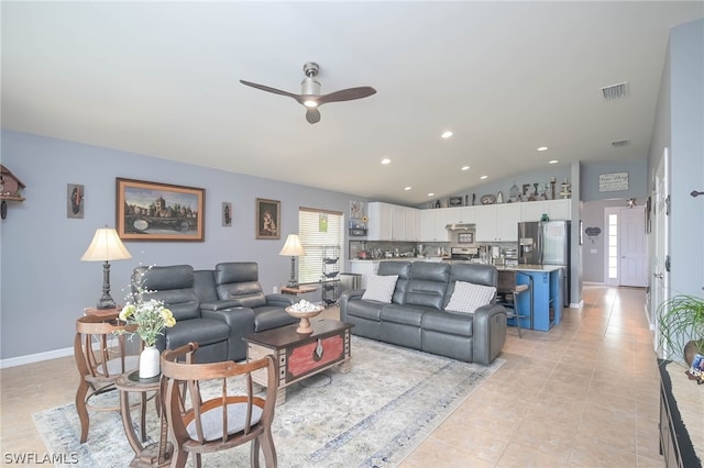 living room featuring ceiling fan, light tile patterned flooring, and vaulted ceiling