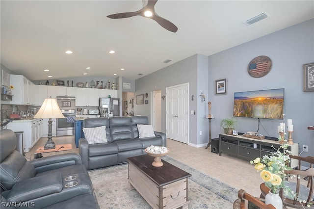 tiled living room featuring ceiling fan