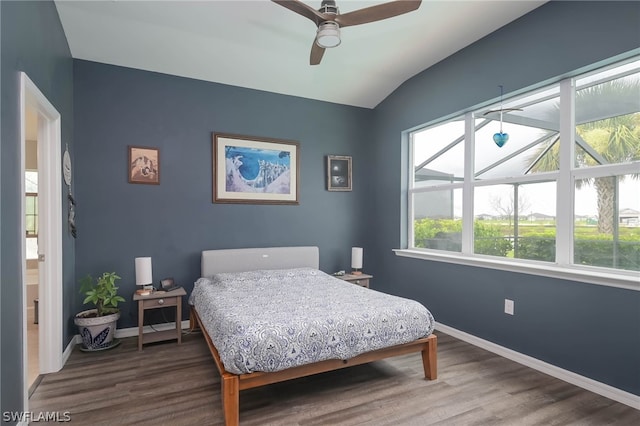 bedroom featuring multiple windows, wood-type flooring, and ceiling fan