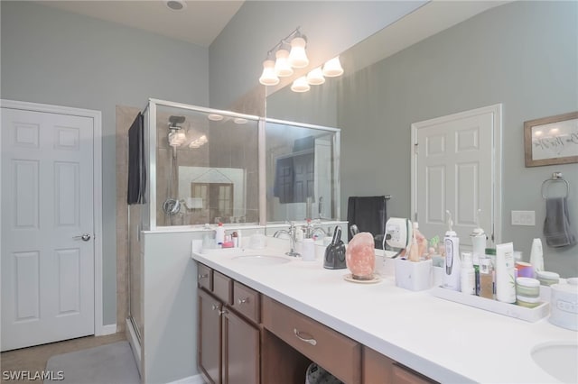 bathroom featuring vanity and a shower with shower door