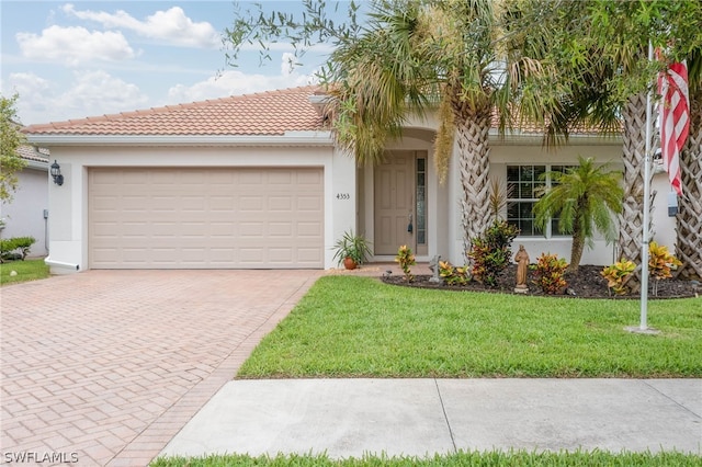 mediterranean / spanish home featuring a front lawn and a garage