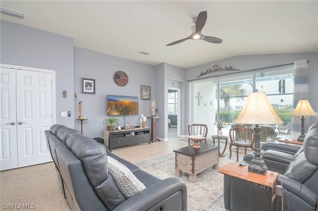 tiled living room with lofted ceiling and ceiling fan