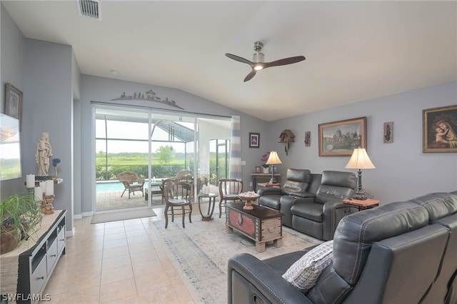 tiled living room with lofted ceiling and ceiling fan