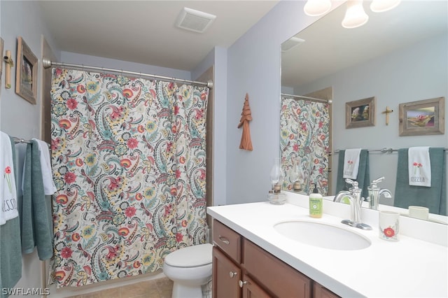 bathroom featuring walk in shower, vanity, toilet, and tile patterned floors