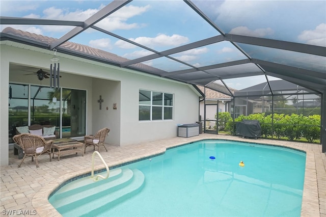 view of pool featuring ceiling fan, a lanai, and a patio area