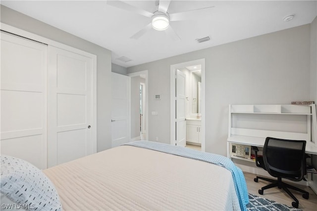 1641 Orleans Ct, Marco Island, FL 34145 - bedroom featuring wood finished floors, a closet, a ceiling fan, ensuite bathroom, and a desk