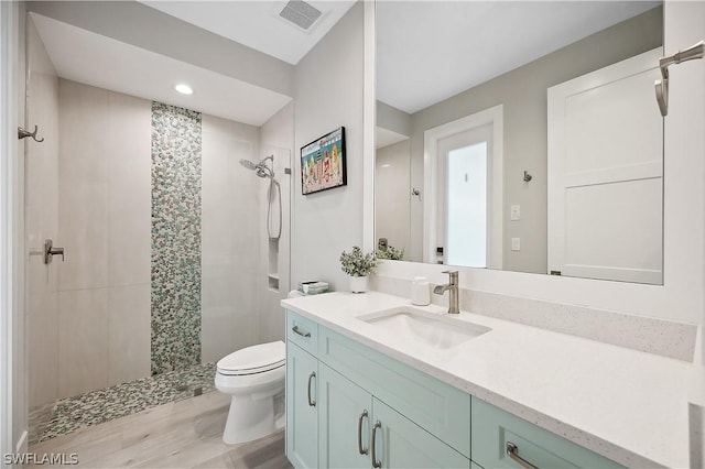 1641 Orleans Ct, Marco Island, FL 34145 - bathroom featuring toilet, a shower stall, wood finished floors, vanity, and recessed lighting