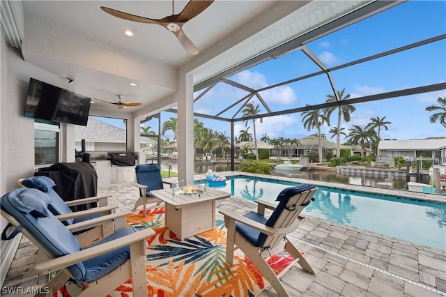 1641 Orleans Ct, Marco Island, FL 34145 - outdoor pool with a ceiling fan, an outdoor kitchen, a patio, a grill, and glass enclosure