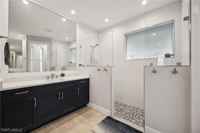 1641 Orleans Ct, Marco Island, FL 34145 - full bathroom featuring a walk in shower, wood finished floors, vanity, recessed lighting, and baseboards