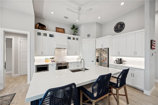1641 Orleans Ct, Marco Island, FL 34145 - kitchen featuring appliances with stainless steel finishes, a sink, decorative backsplash, a breakfast bar area, and recessed lighting