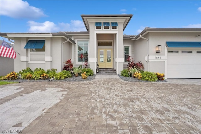 1641 Orleans Ct, Marco Island, FL 34145 - view of front of property with stucco siding, a garage, and decorative driveway