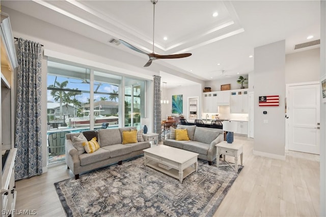 1641 Orleans Ct, Marco Island, FL 34145 - living area with recessed lighting, ceiling fan, light wood-style floors, a raised ceiling, and baseboards