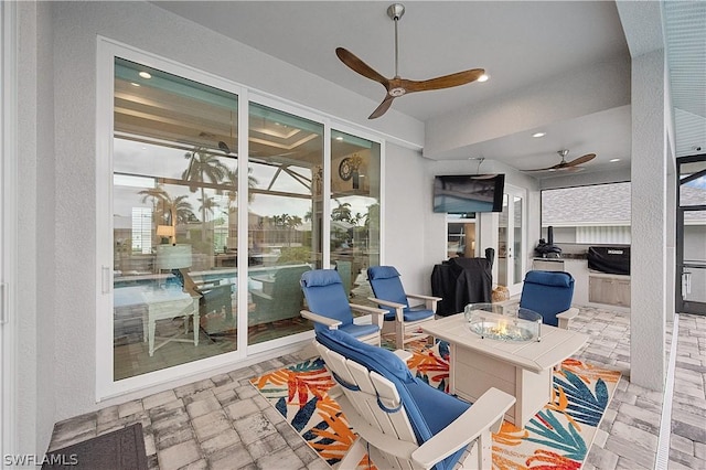 1641 Orleans Ct, Marco Island, FL 34145 - sunroom / solarium featuring ceiling fan, an outdoor fire pit, and exterior kitchen
