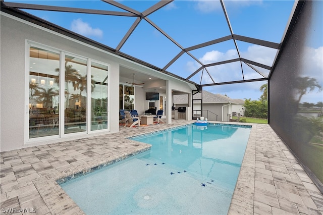 view of swimming pool with glass enclosure and a patio area