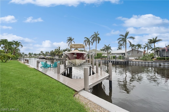 view of dock featuring a lawn and a water view