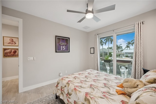 bedroom featuring ceiling fan, light hardwood / wood-style flooring, and access to outside