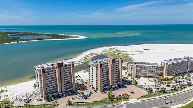 birds eye view of property with a view of the beach and a water view