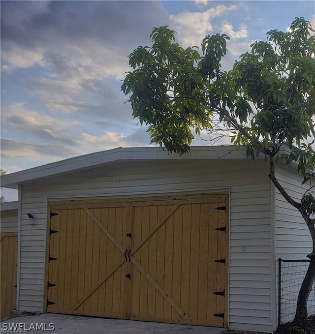 3200 Barrett Ave, Naples, FL 34112 - view of outbuilding featuring a garage, fence, and an outbuilding