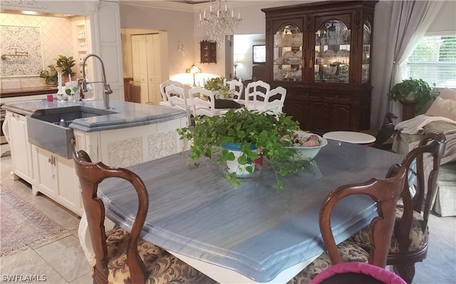 3200 Barrett Ave, Naples, FL 34112 - dining area featuring a chandelier, crown molding, and light tile patterned flooring
