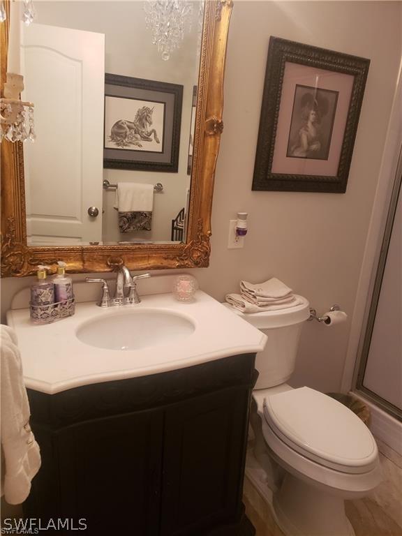 3200 Barrett Ave, Naples, FL 34112 - full bath featuring a shower with shower door, vanity, and toilet