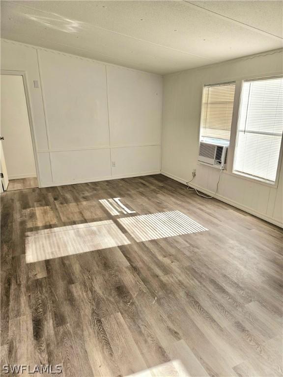 empty room featuring hardwood / wood-style floors and a textured ceiling