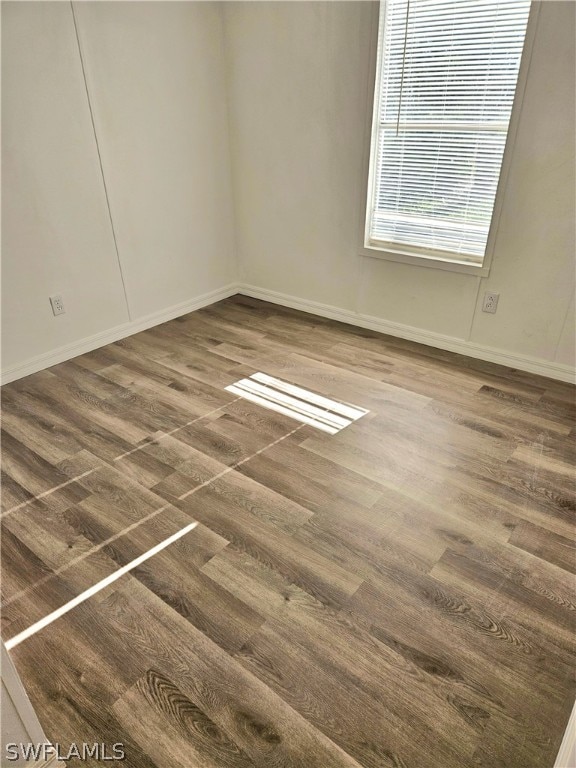 unfurnished room featuring dark hardwood / wood-style flooring