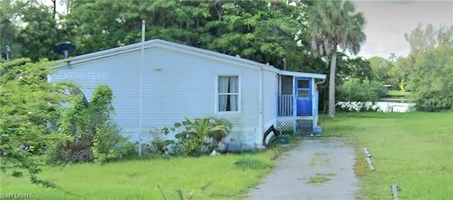 view of property exterior with a lawn