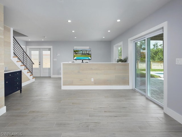 interior space with light hardwood / wood-style flooring and french doors