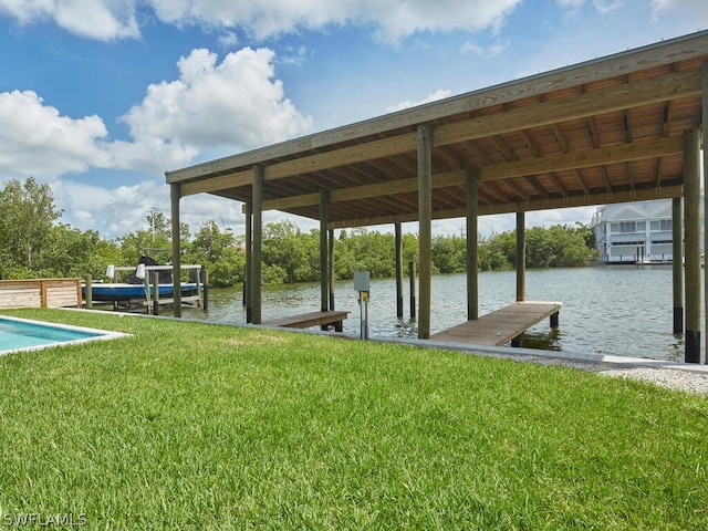 view of dock with a water view and a lawn