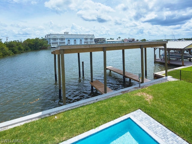 dock area with a water view and a yard