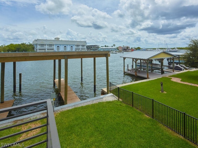 dock area with a lawn and a water view