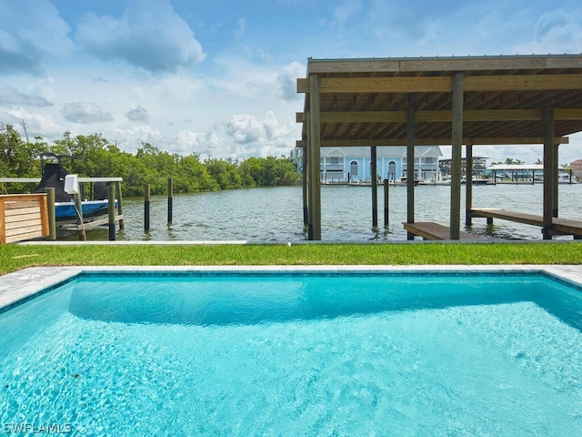 view of swimming pool featuring a water view and a boat dock