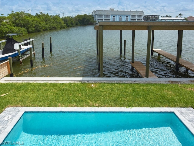 dock area with a water view and a yard