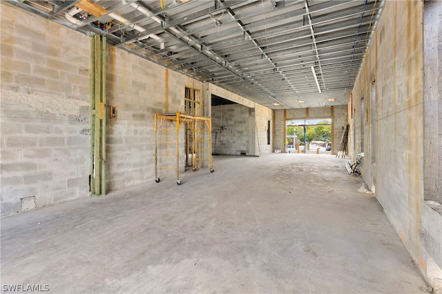 miscellaneous room with a high ceiling and concrete floors